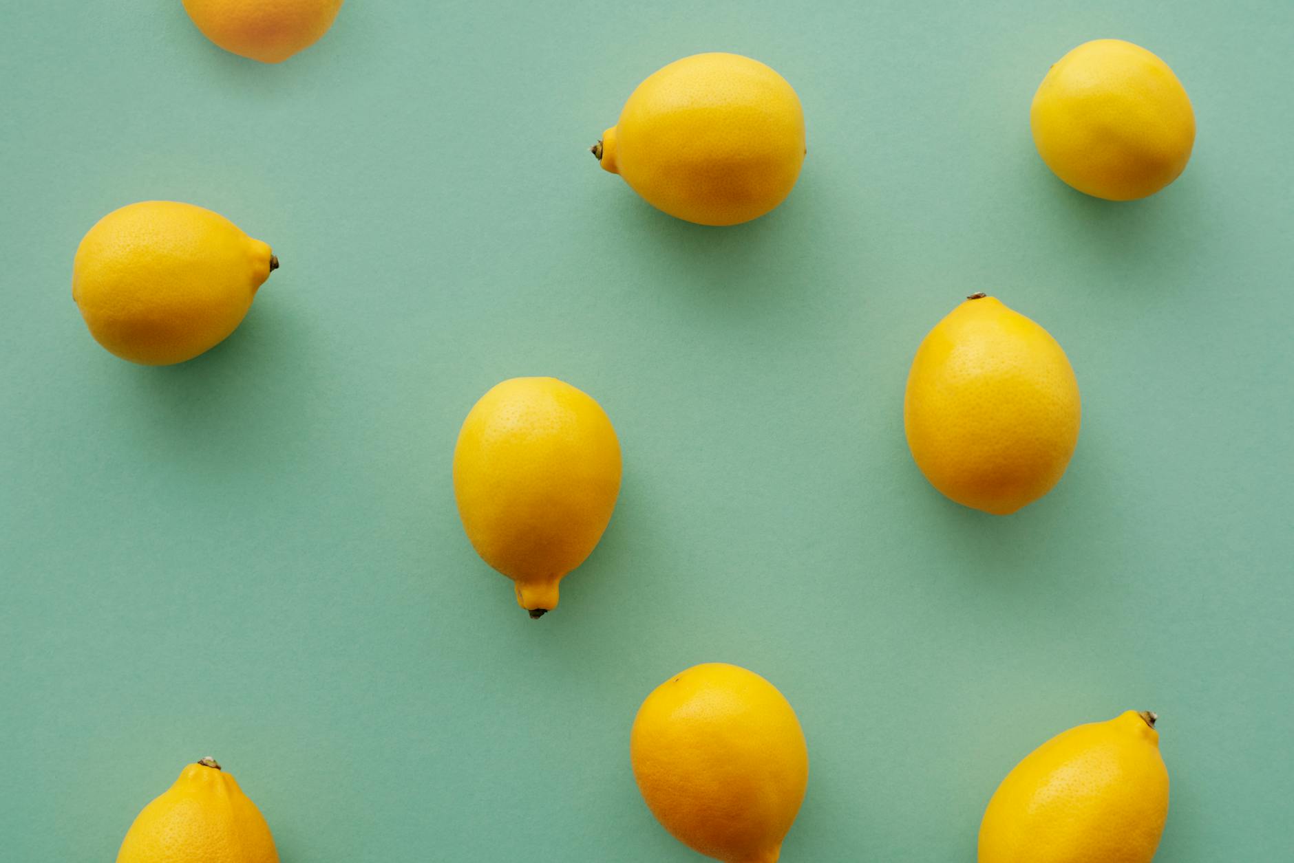 Two women smiling together with fresh lemon slices, expressing joy and openness in a shared moment