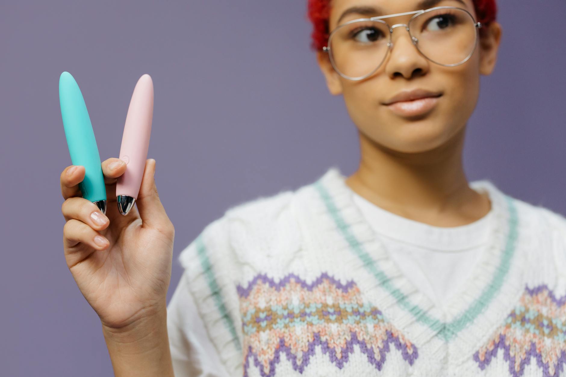 Woman holding colorful vibrators representing lemon clitoral toy options