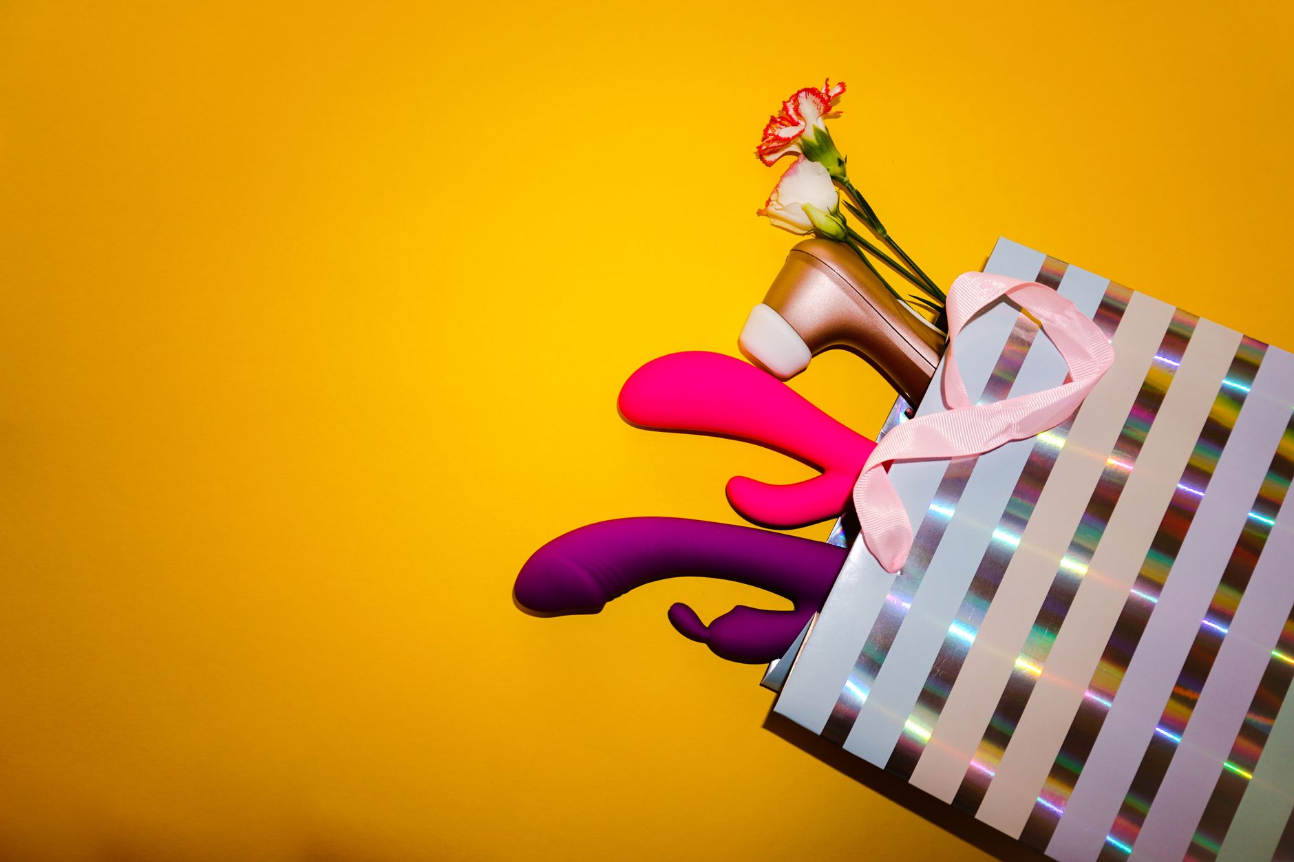 Colorful vibrators with flowers in a holistic setting